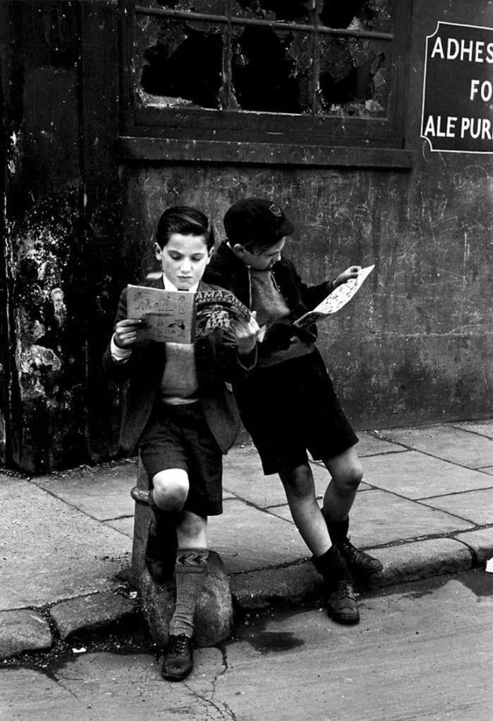 Two Boys Engrossed In Their Comic Books, Outside On The Street, 1952